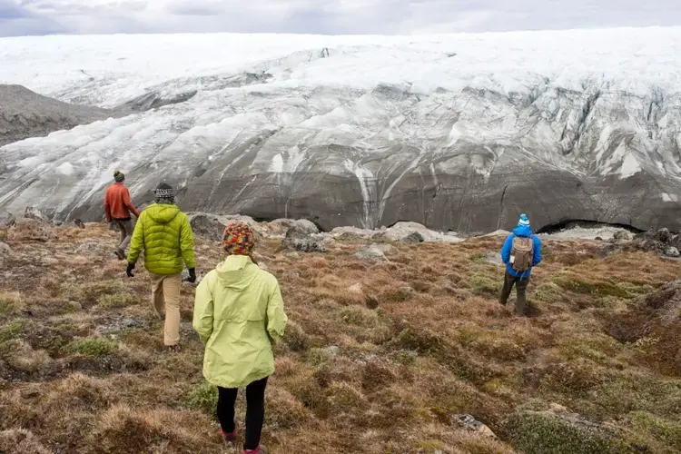 Reporter and photographer Amy Martin says it took awhile to register what she was seeing as the team approached the Greenland ice sheet: not actually mountains, but 3,000-foot-high peaks of solid ice. Image by Amy Martin. Greenland, 2018.