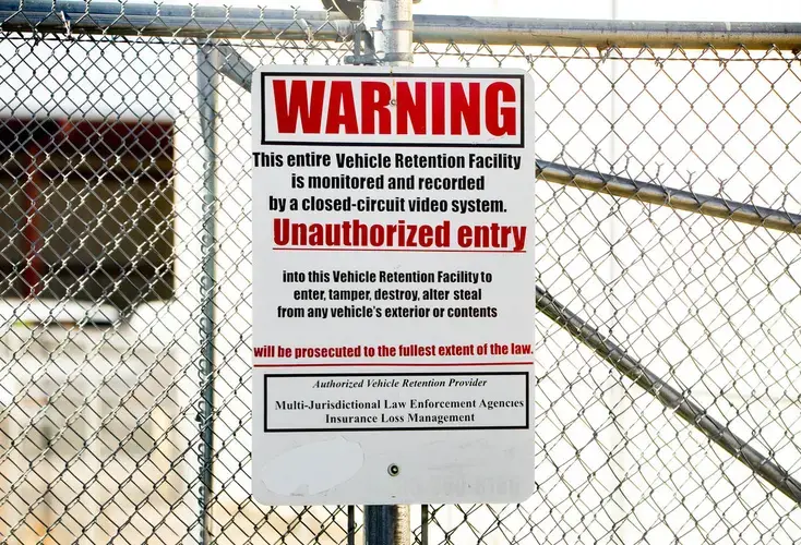 A sign outside the towing company where St. Charles police take people suspected of having illegal substances in their car. Once here, the police search the car and seize any cash or drugs they find. Image by Brian Munoz. United States, 2019.