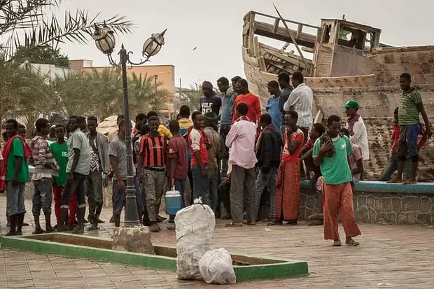 Ethiopians who have run out of money wait at the docks in the town of Tadjoura, en route to Obock, in the hope of securing casual employment. Image by Charlie Rosser. Djibouti, 2018.