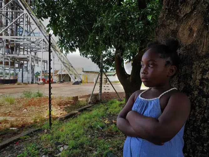 Lead poisoning victim Royce Sakaloa, 6, plays in her backyard less than 50m from the entrance to the former mine. Image by Larry C. Price. Zambia, 2017.