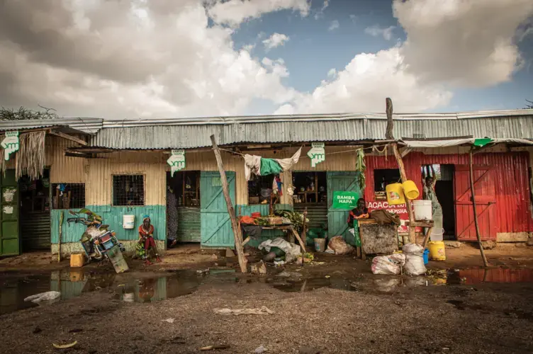 Traders and locals sit outside their stores in the Rendille town of Merille in Kenya. Image by Will Swanson. Kenya, 2020.