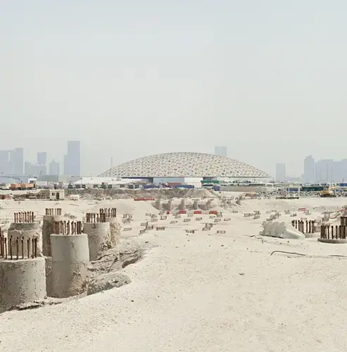 The Louvre Abu Dhabi dome and the site of the Guggenheim’s troubled project. Image by Knut Egil Wang. UAE, 2016