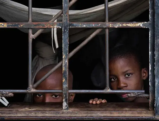 Lead poisoning victims Martin Cilufya, 7, and brother Gift, 10. Their mother said milk rations are the only help offered: ‘They say it is every two months, but sometimes it only comes after six.’ Image by Larry C. Price. Zambia, 2017.