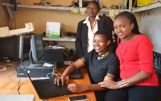 Louisa Kenga, Magdaline Sointa, and Sylvia Nashipae in the cyber cafe that they run out of their home in Narok, Kenya. Image by Janelle Richards. Kenya, 2017.