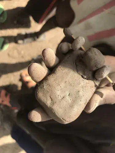 A child holds a clay toy. Image by Jaime Joyce. Kenya, 2018.