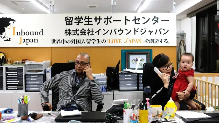 Yusuke Furumi at work in the Inbound Japan office with his Vietnamese colleague, Angel Phan. Image of Emiko Jozuka. Japan, 2018.