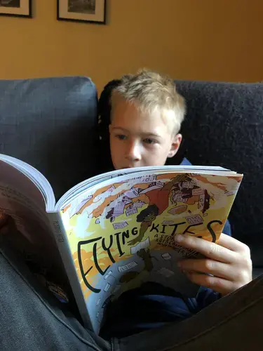 Arthur Van de Weghe reading Flying Kites: A Story of the 2013 California Prisoner Hunger Strike. Image by Tom Van de Weghe. United States, 2019.