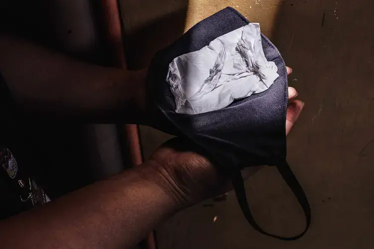 Nurses use tissue paper to add layers of protection to their cloth face masks, which they reuse after washing. Image by Xyza Cruz Bacani. Philippines, 2020.