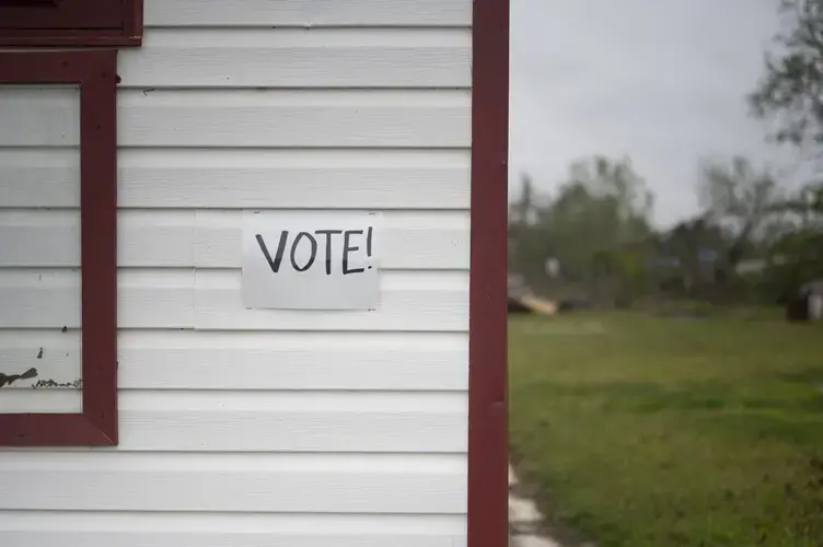 Signs official and handmade encouraging voter turnout plaster the streets of Lake Charles amidst the destruction from back-to-back Hurricanes Laura and Delta and a slow recovery due to COVID-19. Image by Katie Sikora. United States, 2020.