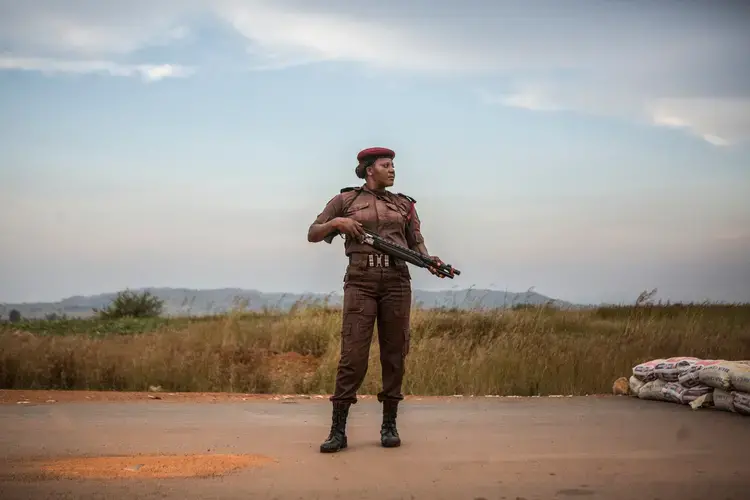 Vigilante Sarah Dung, 39, guards a checkpoint. Image by Jane Hahn. Nigeria, 2018.