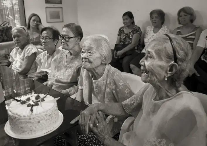 Felicidad delos Reyes (from left), Estela Adriatico, Estelita Dy, Remedios Tecson and Narcisa Claveria celebrate Tecson's and Dy's 89th birthdays on April 27, 2019, at the offices of Lila Pilipina — the League of Filipino Women. Delos Reyes died on Feb. 1, 2020. Image by Cheryl Diaz Meyer. Philippines, 2019.