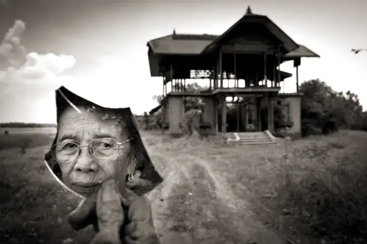 Pilar Quilantang Galang was one of more than 100 girls and women raped by members of the Japanese Imperial Army in the village of Mapaniqui on Nov. 23, 1944. She was 9 years old at the time. Even now, in her 80s, when she sees the ruins of the 'Red House' (at rear of photo), where the rapes happened, she says, 'I feel like I'm losing my mind. I wish it would be destroyed.' Image by Cheryl Diaz Meyer. Philippines, 2019.