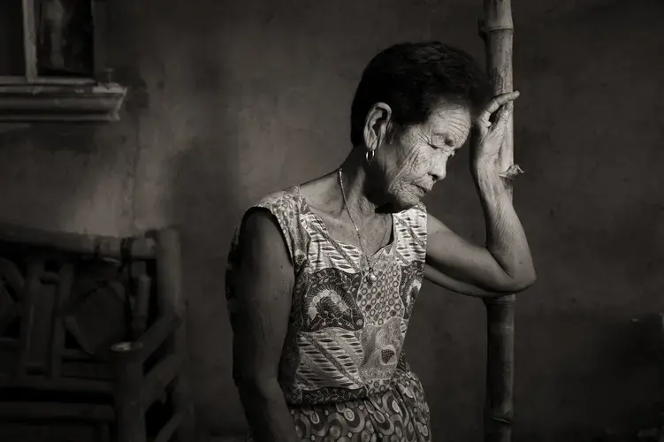 Maria Lalu Quilantang was 9 years old when her village of Mapaniqui was attacked by the Japanese during World War II. Her parents were killed, and she was taken to a building known as the 'Red House,' where girls and women were raped by soldiers. 'We had a deeply painful experience in this house,' she said. 'Whenever I pass by it, my mood always changes.' Image by Cheryl Diaz Meyer. Philippines, 2019.