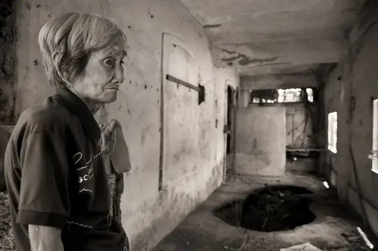 'I'm afraid here. This is not a good place,' said Teresita Bermudez Dayo as she visited the remains of the Belo Mansion, where she was imprisoned and forced to serve as a 'comfort woman' during World War II. Japanese soldiers had stopped her family when the family was traveling, declared that the 12-year-old was pretty and took her to their armored vehicle. Image by Cheryl Diaz Meyer. Philippines, 2019.