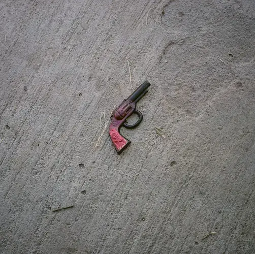 A toy gun is seen in front of the home of Reyna Patricia Ambroz Zapatero, September 25, 2020. Image by by Christopher Lee. Mexico, 2020.