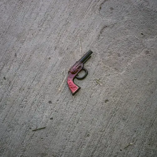 A toy gun is seen in front of the home of Reyna Patricia Ambroz Zapatero, September 25, 2020. Image by by Christopher Lee. Mexico, 2020.