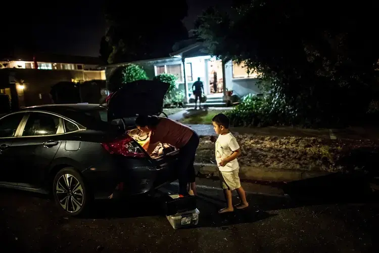SONOMA COUNTY, CALIF. Erika González and her son, Kevin, evacuating their home as the L.N.U. Lightning Complex fire approached in August. Image by Meridith Kohut. United States, 2020.