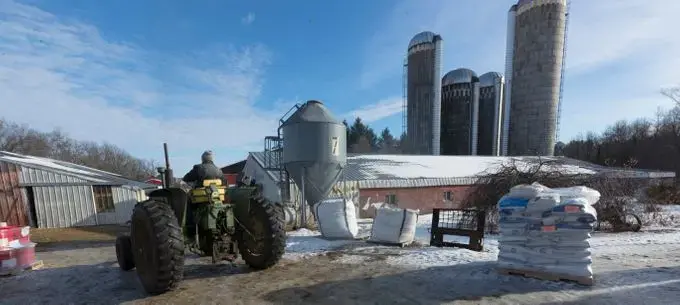 Chuck Spaulding moves his 1964 John Deere tractor into a shed while doing chores. Image by Mark Hoffman/The Milwaukee Journal Sentinel. USA, 2019.