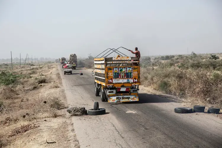The daily convoy from Maiduguri to Damboa. Despite its military escort, Boko Haram periodically attacks the convoy, abducting and killing travelers and stealing vehicles. Image by Glenna Gordon. Nigeria, 2017.