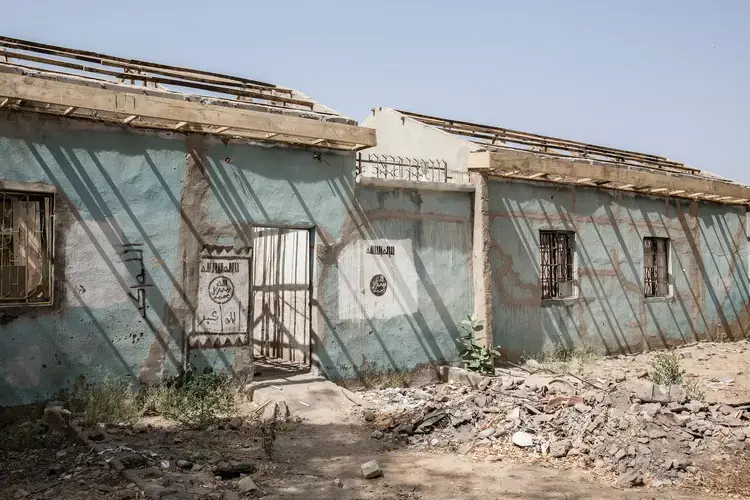 The Nigerian military retook Bama, a large town in northeastern Nigeria, from Boko Haram in 2015. The insurgents burned many buildings as they fled, but some that still stand display markings that show Boko Haram’s affiliation with ISIS. Image by Glenna Gordon.