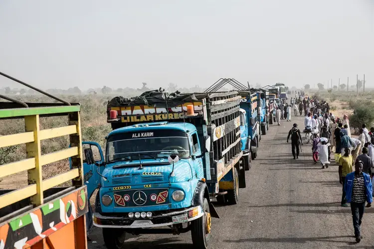 A convoy lining up just outside Maiduguri before departing under military escort for Damboa, a small town a few hours away. Travel through Borno State is extremely dangerous. Image by Glenna Gordon. Nigeria, 2017.