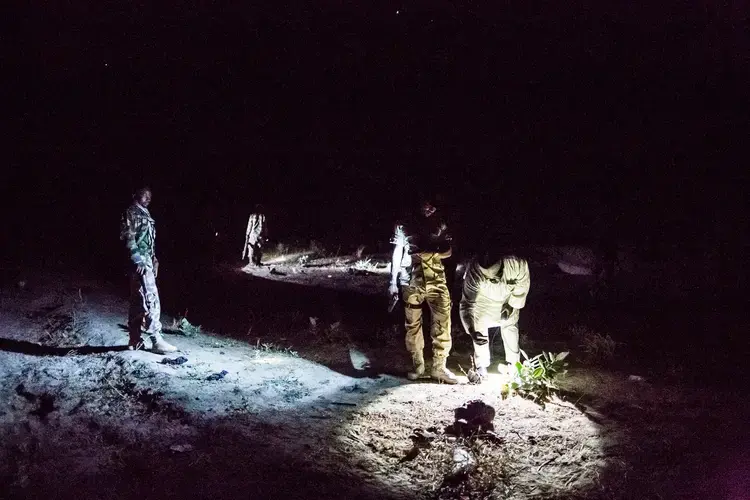 Soldiers examining the remains of a suicide bomber. Image by Glenna Gordon. Nigeria, 2017.