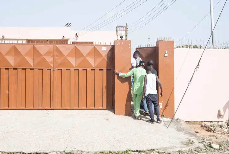 Some faithful and friends are waiting for Prophet Courage Aheavens to leave his house. Image by Tomaso Clavarino. Ghana, 2018.
