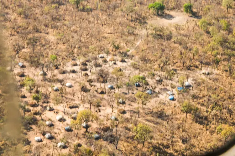 One afternoon, several Chinko employees flew out by helicopter to meet with the displaced community sheltering in the park. Image by Jack Losh. Central African Republic, 2018.