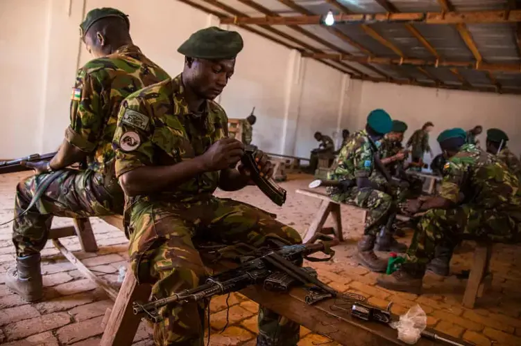 Rangers practise taking apart and reassembling their rifles during a training session. Image by Jack Losh. Central African Republic, 2018.
