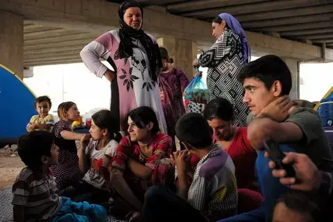 Bayan Hadli, 36, is from the village of Tembanar. She lives under a motorway bridge near the Iraqi city of Dohuk. Her eldest daughter, Bushara, has been abducted by ISIS. The father of the family is missing. Image by Lam Duc Hien/Agence VU. Iraqi Kurdistan, 2014.