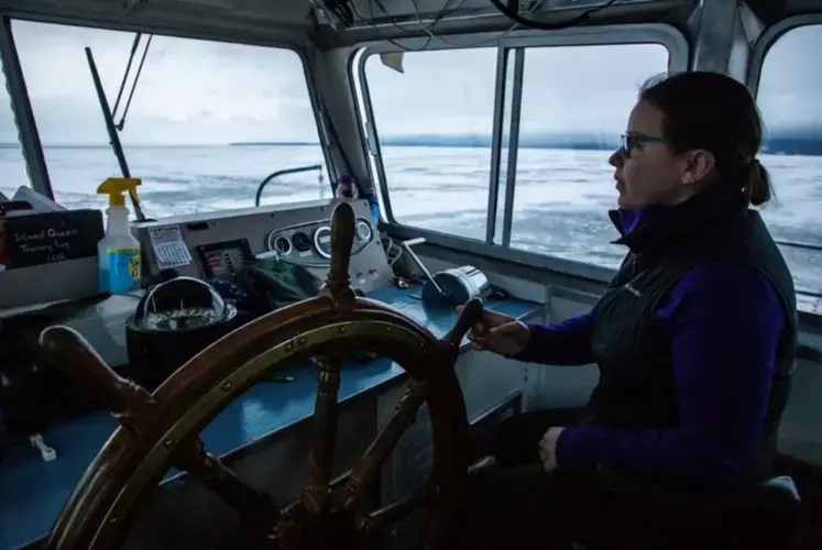Capt. Shannon Mager steers a ferry boat through open waters of Lake Superior from Bayfield, Wisconsin, to Madeline Island on Jan. 23, 2020. Image by Zbigniew Bzdak/The Chicago Tribune. United States, 2020.