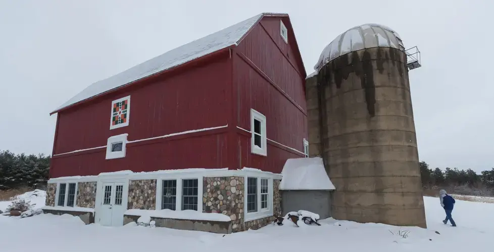 Former dairy farmer Greg Zwald walks to the renovated barn he uses as an event space at his White Pine Berry Farm. Image by Mark Hoffman. United States, 2019.