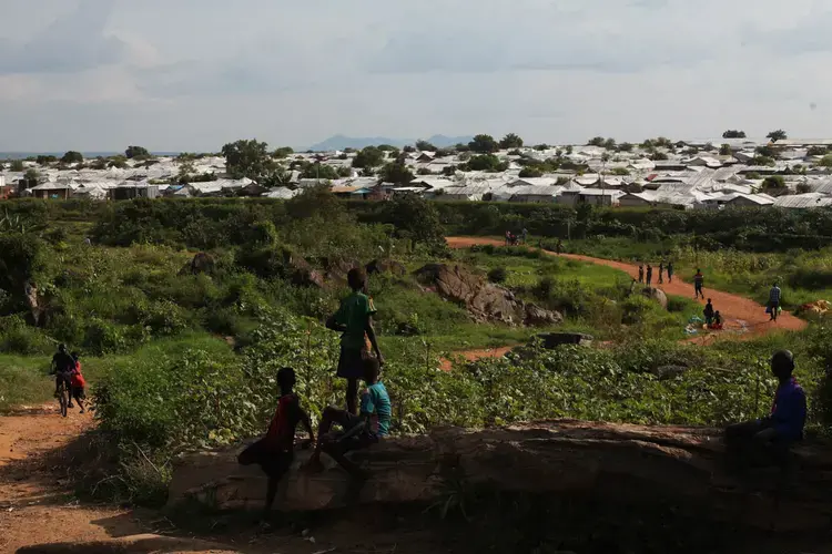 Children walk outside the POC in Juba, South Sudan, home to more than 40,000 people. Image by Andreea Campeanu. South Sudan, 2018.