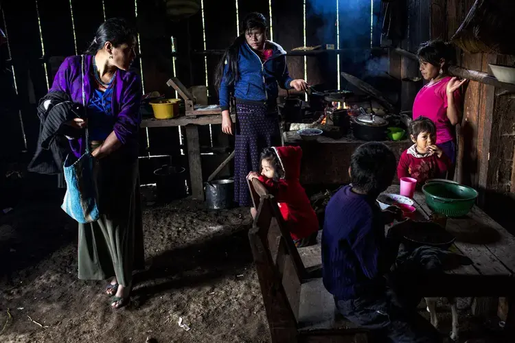 María García Domingo, 33, leaves home to go to work in the coffee harvest, while her 5 daughters and one son have breakfast. Image by Simone Dalmasso. Guatemala, 2019.