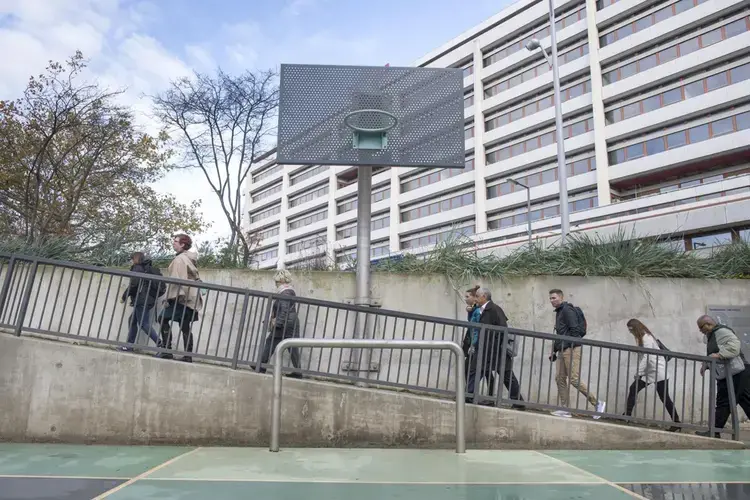 Louisiana, Texas, and Florida public officials tour a water plaza in downtown Rotterdam. The mixed-use space is also used as a basketball court when not holding rain water. Image by Chris Granger. Netherlands, 2019.