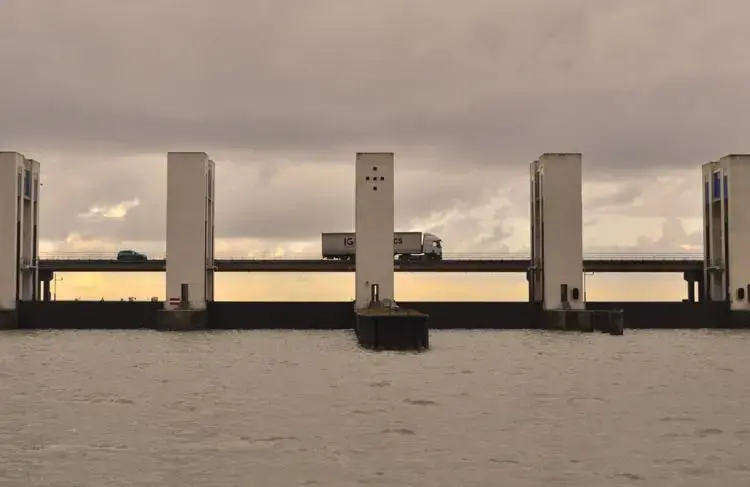 Vehicles pass over a series of locks that regulate the flow of water between Marker Lake and a large bay north of Amsterdam. Image by Tristan Baurick / Times-Picayune | The Advocate. The Netherlands, 2020.