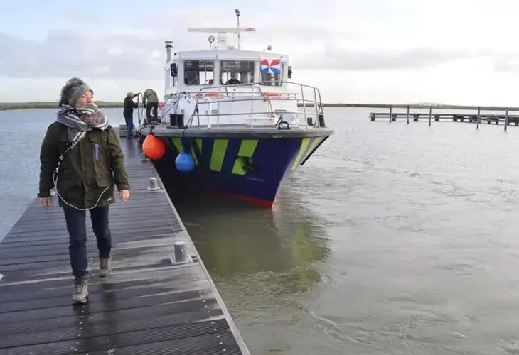 A supply boat staffed by volunteers docks at the Marker Wadden, a series of artificial islands north of Amsterdam. The islands are part of a project aimed at restoring a lake harmed by a large dam. Image by Tristan Baurick / Times-Picayune | The Advocate. The Netherlands, 2020.