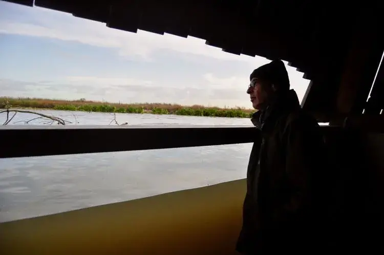 Roel Posthoorn, director of the Marker Wadden, looks out from a partially submerged shelter on an artificial island north of Amsterdam. Image by Tristan Baurick / Times-Picayune | The Advocate. The Netherlands, 2020.