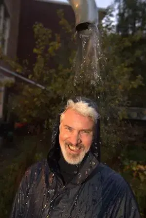 Rainbeer founder Joris Hoebe laughs while standing under a downspout in Amsterdam. Image by Chris Granger / The Times-Picayune | New Orleans Advocate. Netherlands, undated.