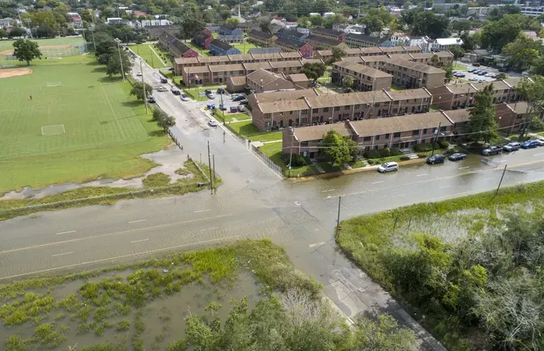 The intersection of Line Street and Hagood Avenue during a high tide just before noon on Sunday, Sept. 20, 2020, in Charleston. Residents in the nearby Gadsden Green public housing complex are impacted by the area’s regular flooding. Image by Andrew J. Whitaker / The Post and Courier. United States, 2020.</p>
<p>