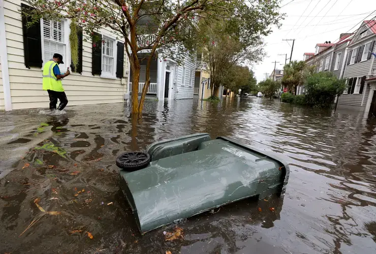 Keith Davis, who works at Ashley Hall, films the flooding from heavy rains on Vanderhorst Street on Friday, Sept. 25, 2020, in Charleston. Image by Grace Beahm Alford / Post and Courier. United States, 2020.