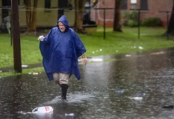 The Post and Courier’s watchdog and public service editor Glenn Smith collects a sample of water from America Street on Wednesday, May 27, 2020, in Charleston. Image by Gavin McIntyre / Post and Courier. United States, 2020.