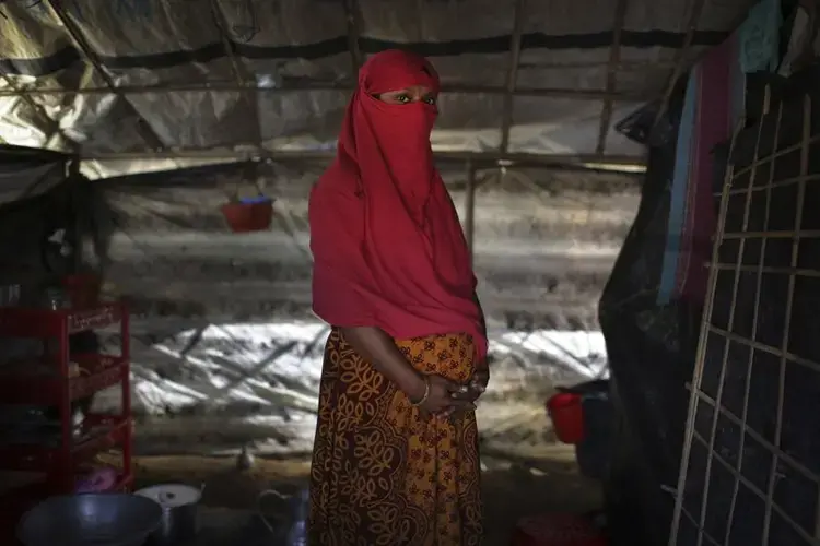 F, 22, clutches her hands around her pregnant belly. Image by Wong Maye-E. Bangladesh, 2017.