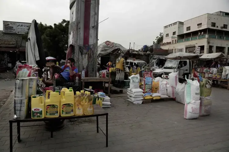 A man sells aid supplies at a market in Aden. Image by Nariman El-Mofty/AP Photo. Yemen, 2018.