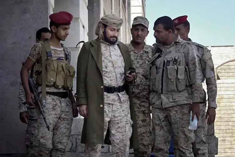 Adnan Rouzek, center, stands with fighters in Taiz. Image by AP. Yemen, 2017.