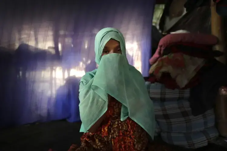 F, 22, pregnant, prays in her tent in Kutupalong refugee camp in Bangladesh. Image by Wong Maye-E. Bangladesh, 2017.