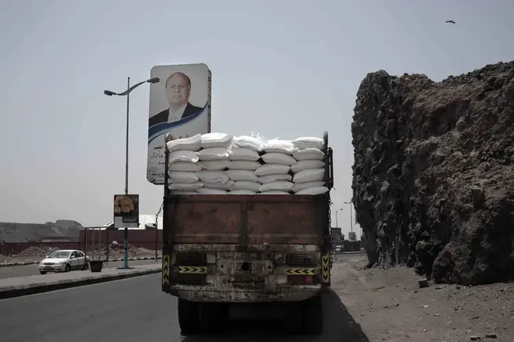 A truck carries aid on a road in Aden. Image by Nariman El-Mofty/AP Photo. Yemen, 2018.