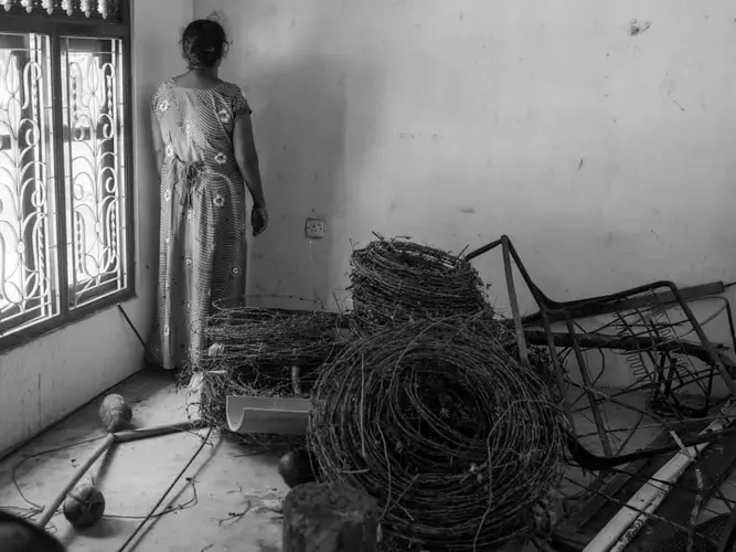 A Tamil woman returns to her home years after the Sri Lankan army confiscated the property and land after the end of the war in 2009. Image by Moises Saman. Sri Lanka, 2018.