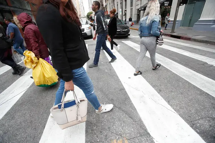 Romina walks through downtown Los Angeles after appearing in immigration court. Romina fled the violent state of Guerrero in 2017 and sought asylum in the United States. Image by Omar Ornelas/The Desert Sun. United States, 2018.