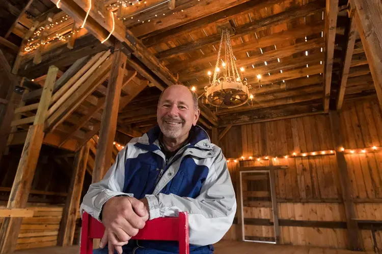 Former dairy farmer Greg Zwald inside of the renovated barn he uses as an event space at his White Pine Berry Farm outside River Falls. Image by Mark Hoffman. United States, 2019.